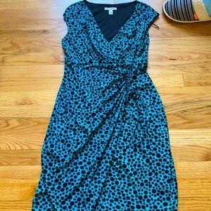Turquoise dress with black polkadots.
